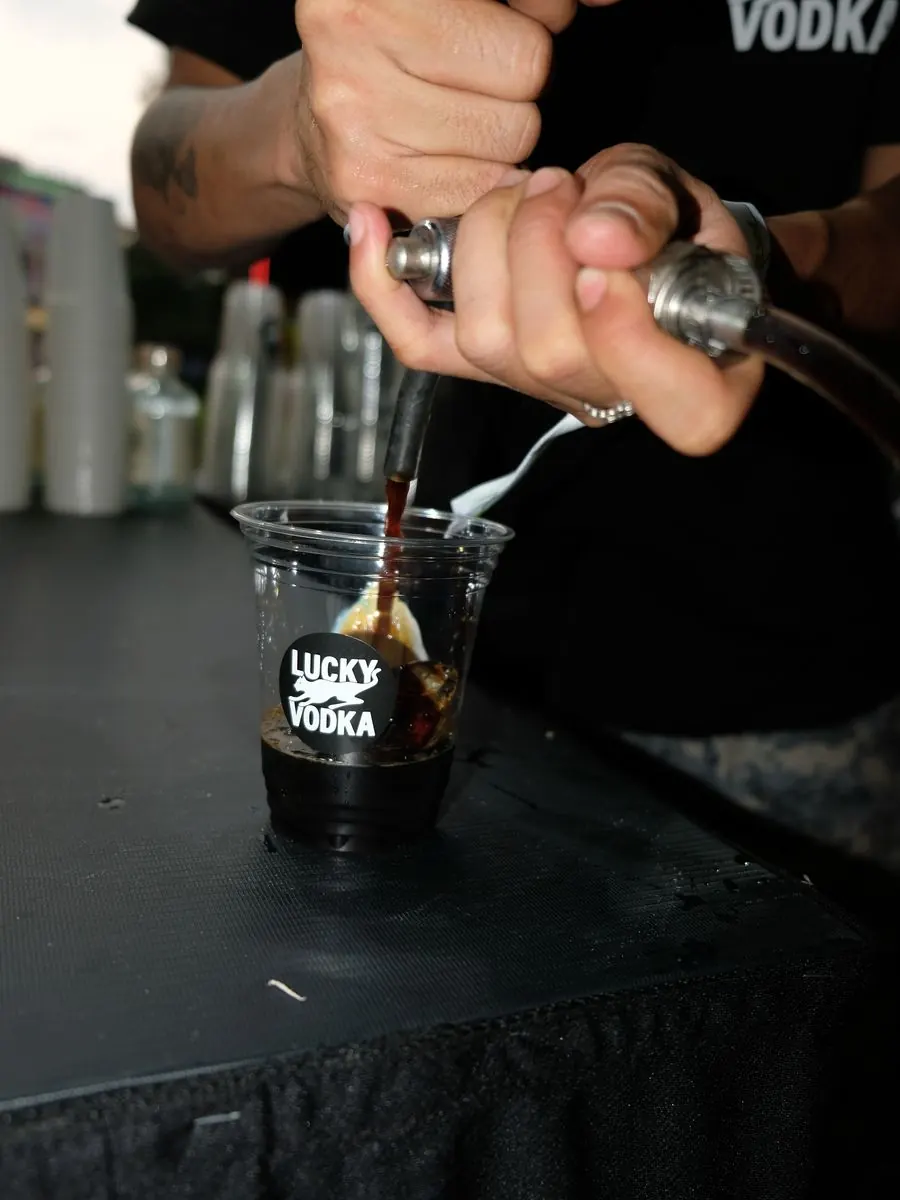 A bartender pouring a Lucky Vodka cocktail