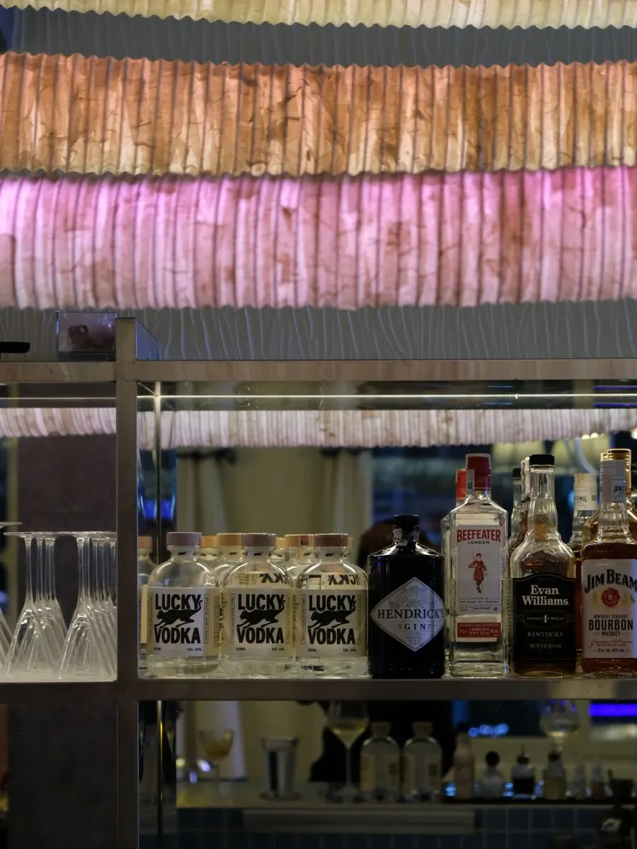 Lucky Vodka on a back bar under pink lights